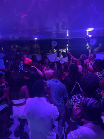 End of Summer Glow Party on board ÜberVida Bermuda’s Celebration Yacht – guests dancing under blacklights, wearing neon and white outfits, with ocean views and open bar on Saturday, September 20, 2025.