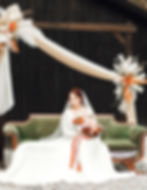 bride sitting on a bench with bouquet