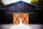 bride in front of the venue's barn doors