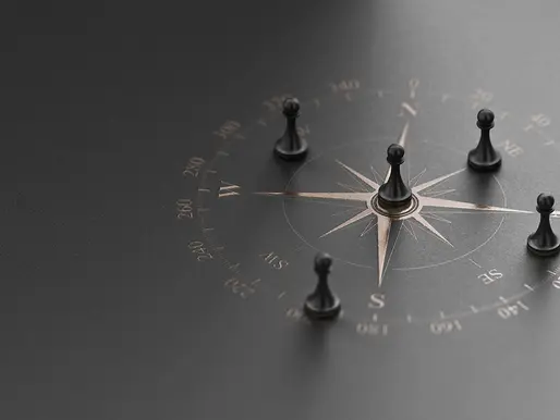Compass with game pieces positioned around it, symbolising the navigation and strategy required for creating a comprehensive financial plan