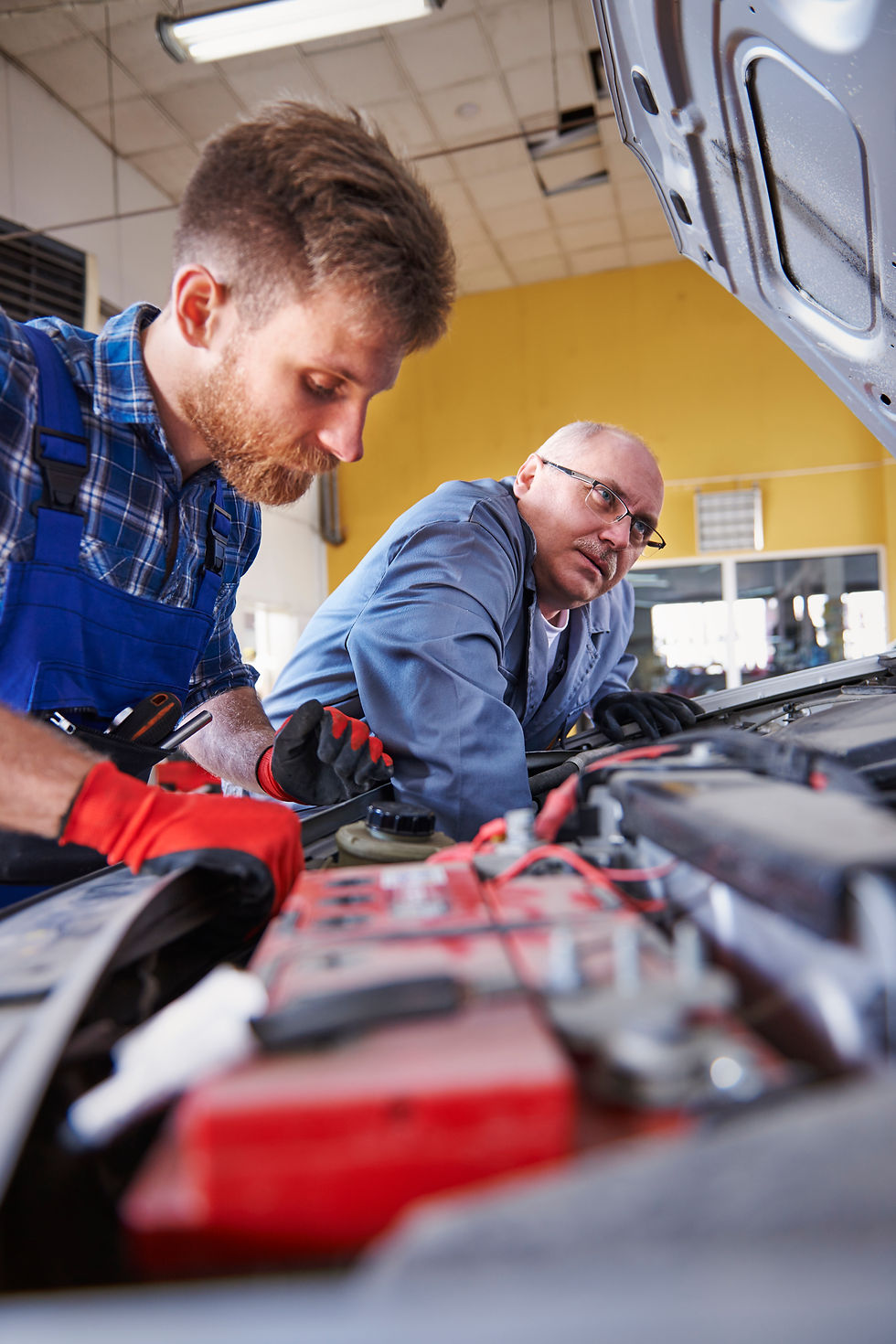 mechanics-repairing-car-workshop.jpg