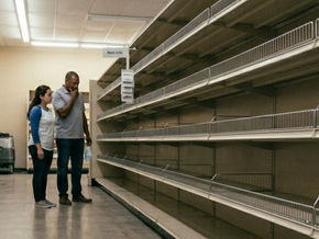 Man and woman looking at empty shelves