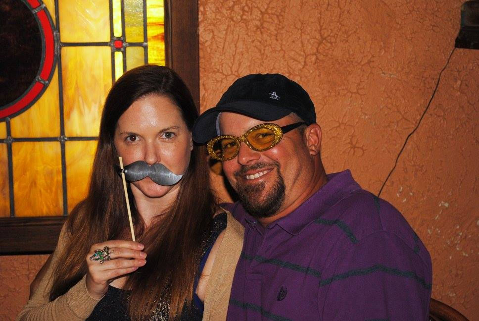 Photo of the two founders, a brunette white woman with dark eyes, a brunette white man with dark eyes, beard, and mustache.