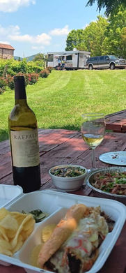 a bottle of wine next to a sandwhich