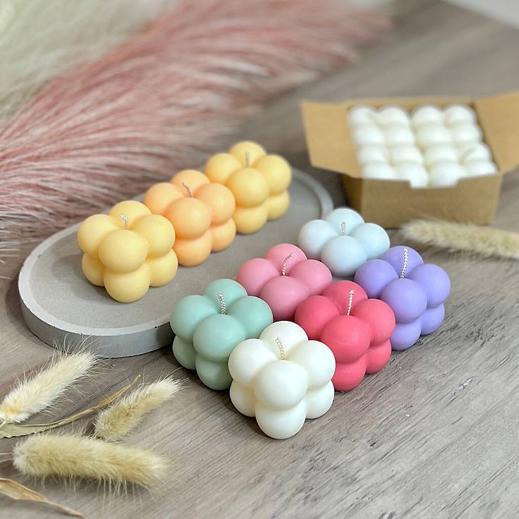 Pastel bubble candles with white candles in a box