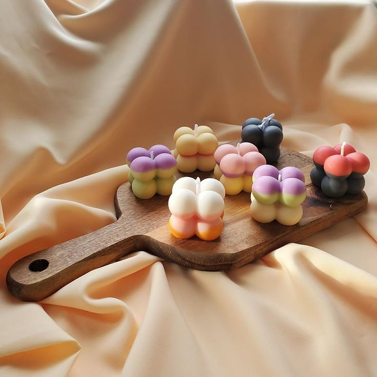 Multicolored bubble candles on a wooden board