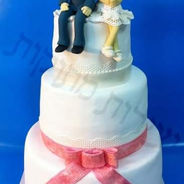 3 Tiered Custom Wedding Cake, with Pink Bow and Cute Edible Sculptered Figures of the Groom & Bride on Top, and Edible Lace. Everything is Edible!