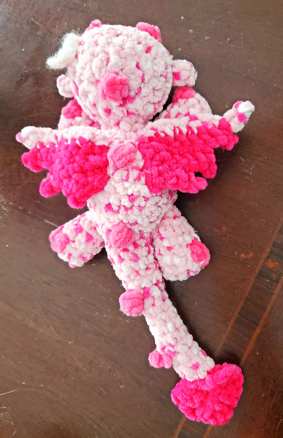 Thumbnail: top view of pink dragon plush with wings spread out