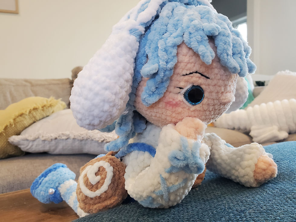 Thumbnail: side view of doll posed laying down showing sweater and purse details