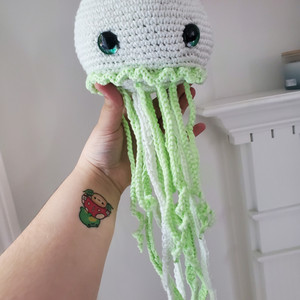 white jellyfish plush with white and green tentacles