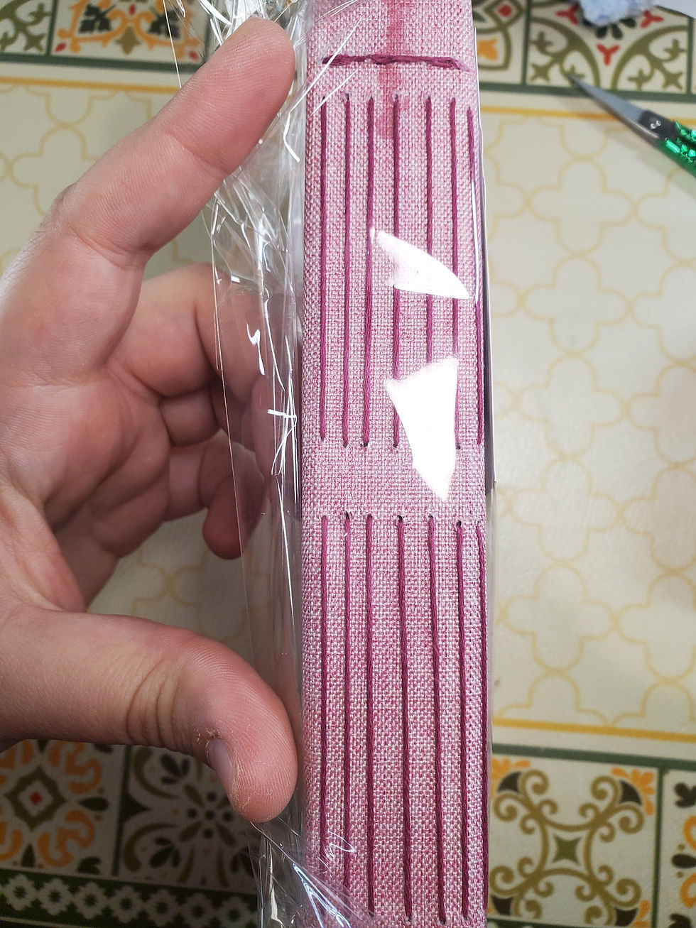 Thumbnail: Spine with long stitch of handbound pink notebook