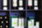 A shelf of Italian wine bottles and olive oils for sale featured in Florence wine tours + Tastings in Tuscany: Le Montanine ©AlonzoWright for Manifesting Travel