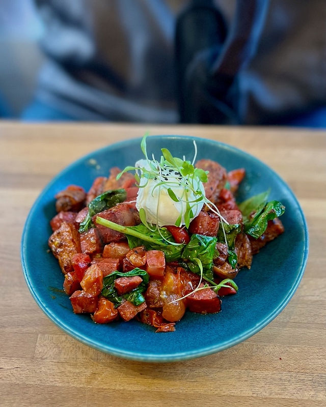 A blue bowl of chorizo and sweet potato hash served at The Green Bird Cafe restaurant in Bath UK are a local favorite @AOnozWright for Manifesting Travel ©AOnozWright