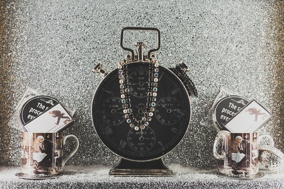 A shop window displaying a Swiss black and chrome clock with jeweled necklaces draped around it. Shopping for special timepieces is one of the Things to do in Lucerne all year round ©AlonzoWright for Manifesting Travel