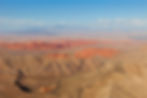 Valley of Fire State Park from a helicopter with rich orange mountains and desert landscapes as far as the eye can see.