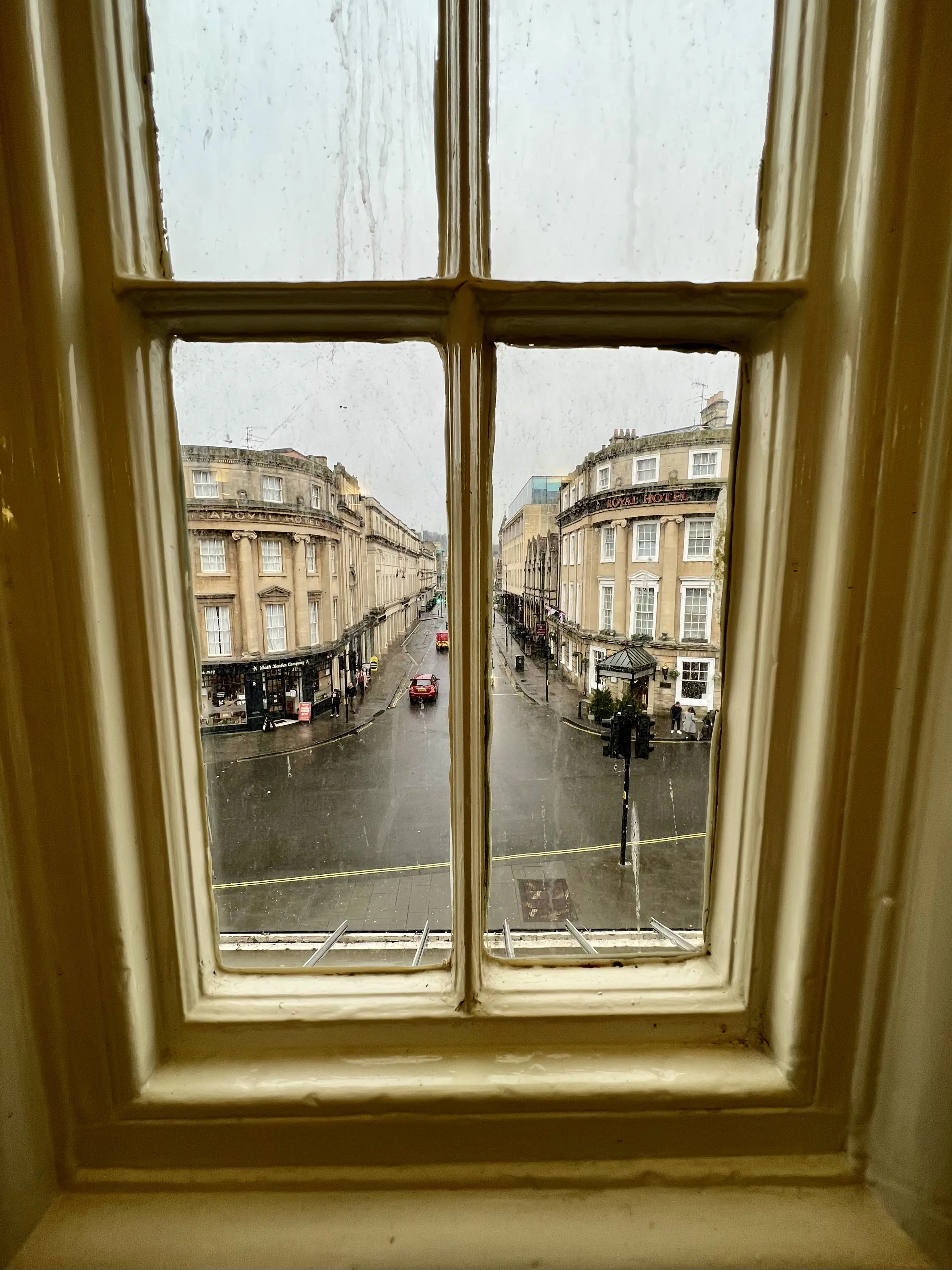 The interior view of Bath's train station looking down the cobblestone streets of a dreary Bath, England ©AOnozWright