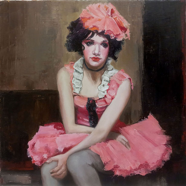 A young woman in vintage pink music hall dress and bonnet looking reflective