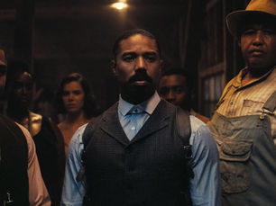 A group of serious individuals stands in dim lighting, featuring men in vests and a man in overalls with a hat, in a wooden interior.