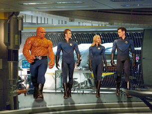 Four people (Fantastic Four: Rise of the Silver Surfer) in futuristic suits walk confidently in a high-tech, metallic room. One has an orange, rocky texture. Mood is determined.