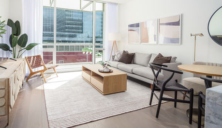 Open-concept living and dining space with sofa, dining chairs, and bench