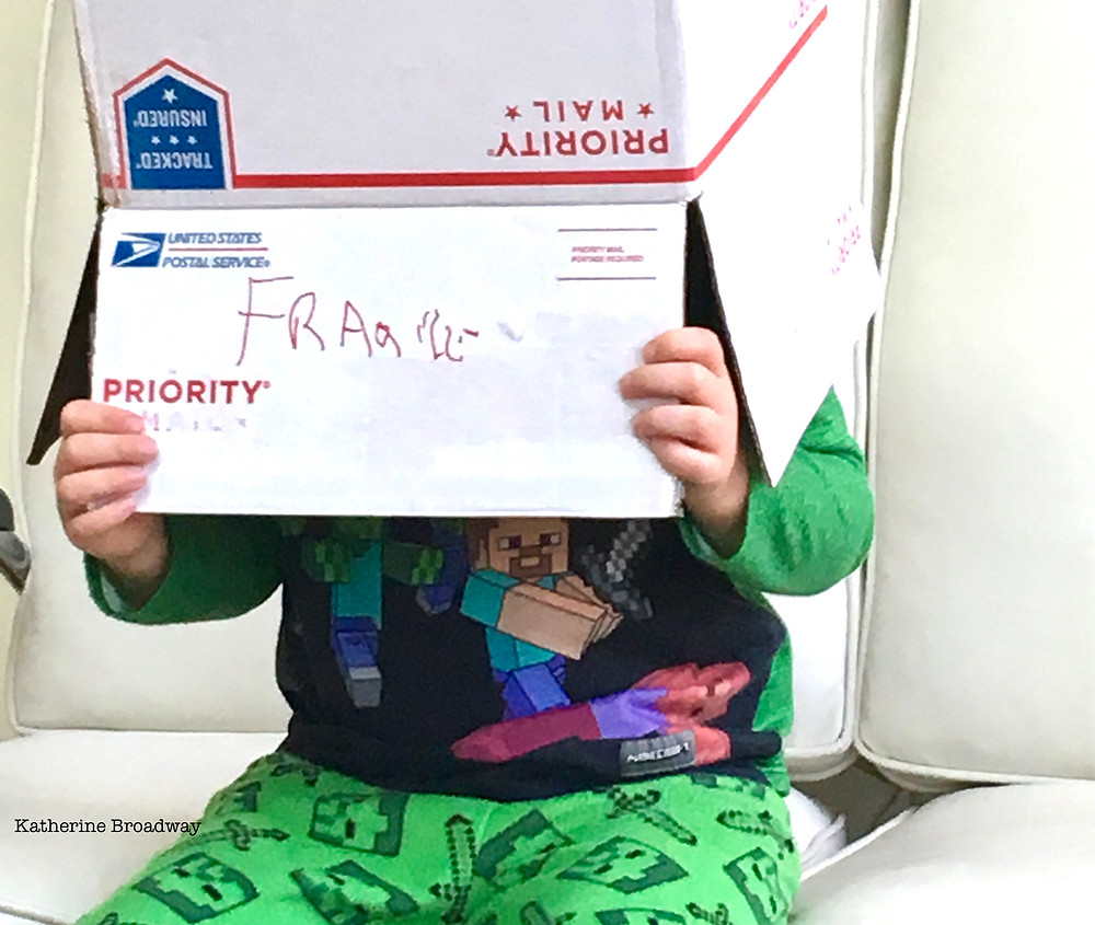 Image of child with priority mail box on their head.