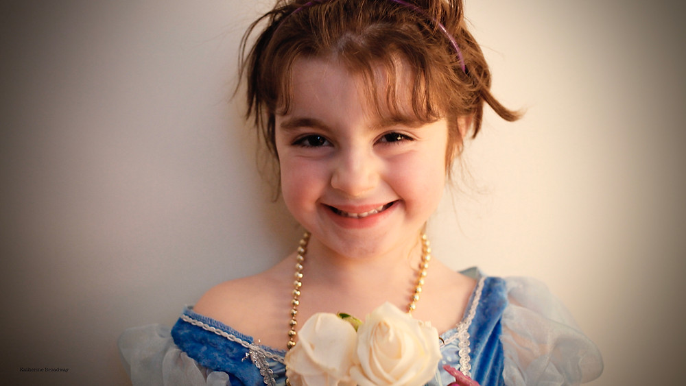 Image of young girl holding white roses.