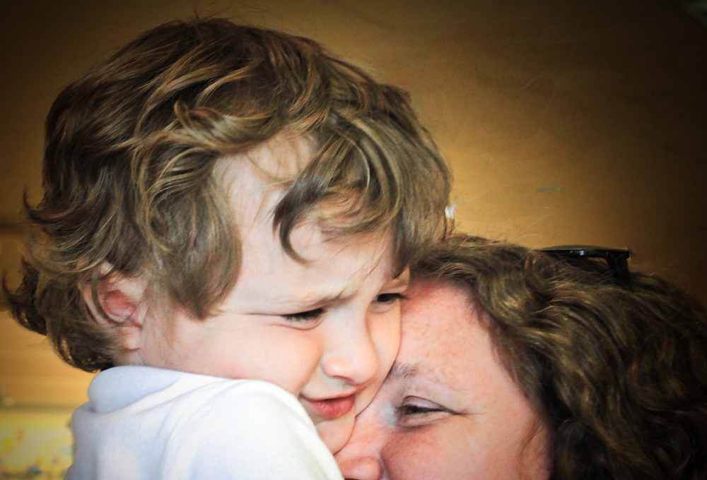 Image of worried child hugging his mom. Raleigh Psychotherapy, counseling, bad news, Katherine Broadway