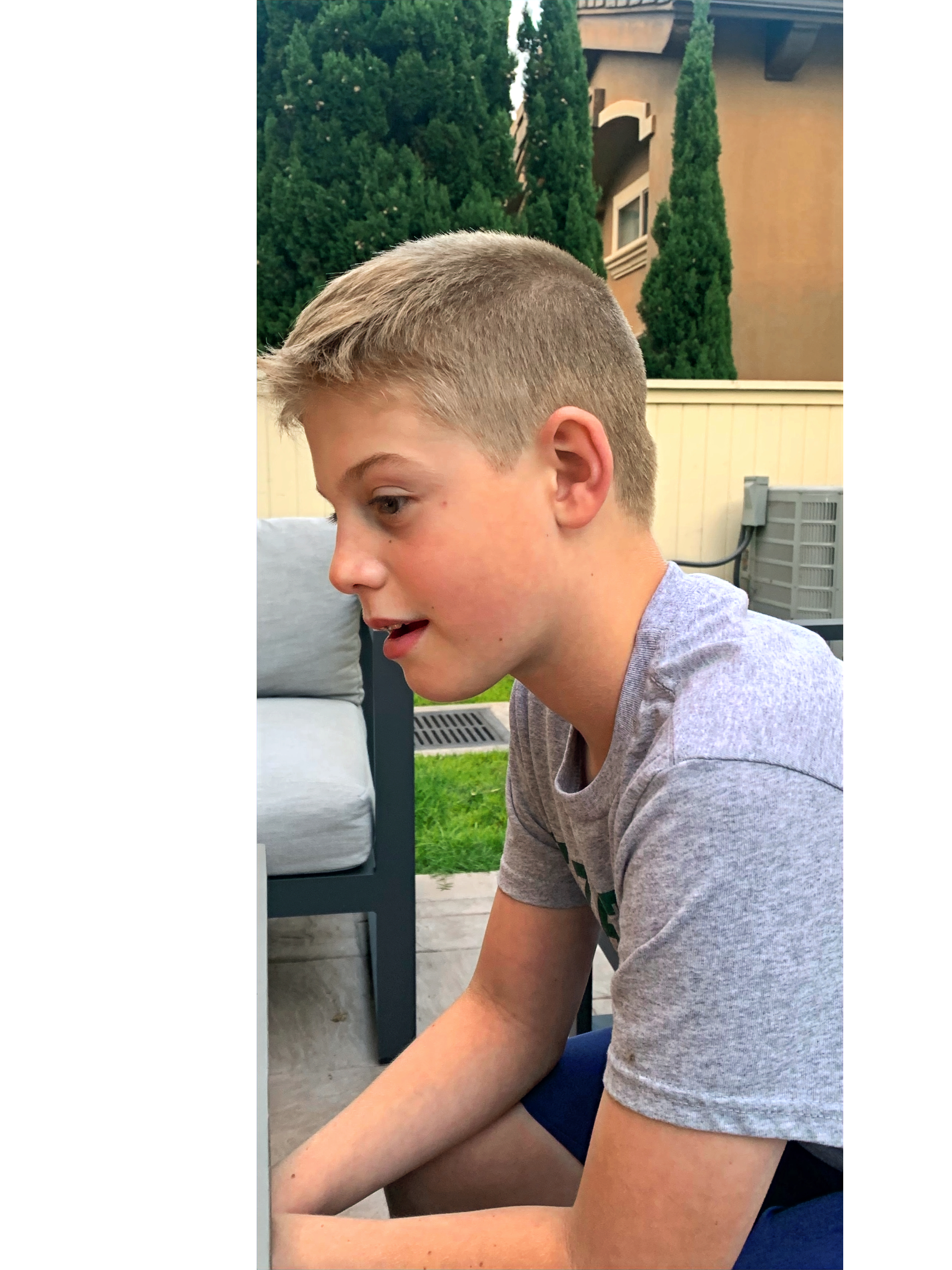 Carter Veilleux's side profile, sitting outside