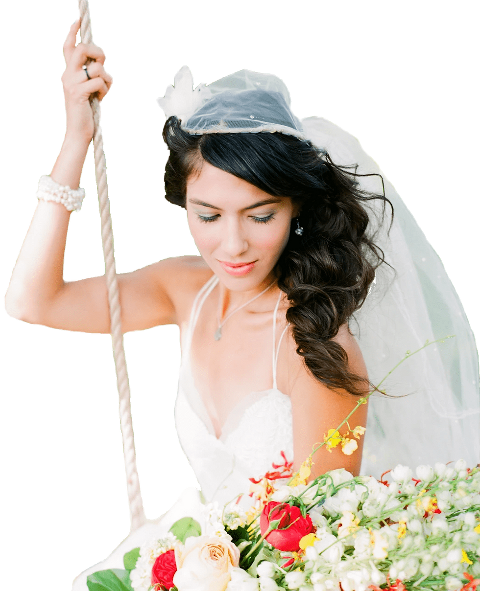 Woman with stylized hair in wedding dress on swing