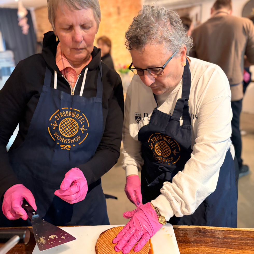 Two women working together to make fresh stroopwaffels
