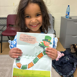 Young student smiling during a fun, varied music lesson at Scotia Suzuki School Halifax