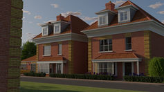 A pair of identical red brick detached houses on a new development in the early morning, viewed from beside a similar house on the opposite side of the street. The houses have red tiled roofs and dormer windows and are on a quiet residential road.
