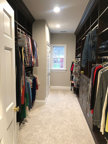 Large walk-in closet with custom cabinetry