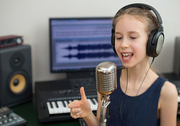 Little girl singing a song in home recording studio..jpg