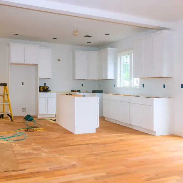 kitchen under renovation with white cabinets and wood floors, square