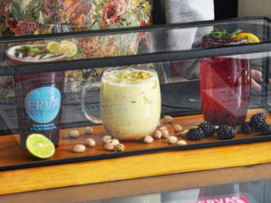 Three Erva Brew yerba mate drinks in different flavors served on a countertop.