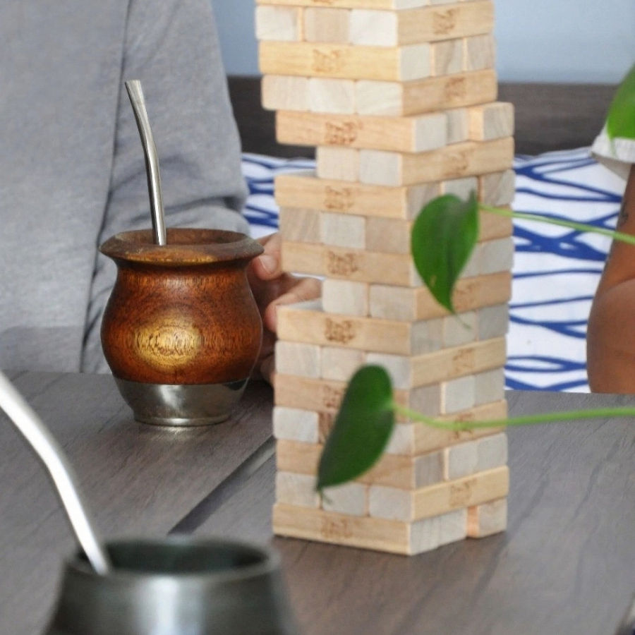 A group of people playing Jenga with Erva Brew Yerba in their gourds.