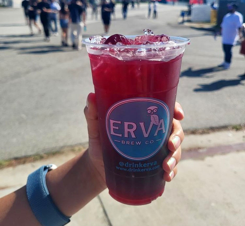 A person holding an Erva Brew drink in a California street.