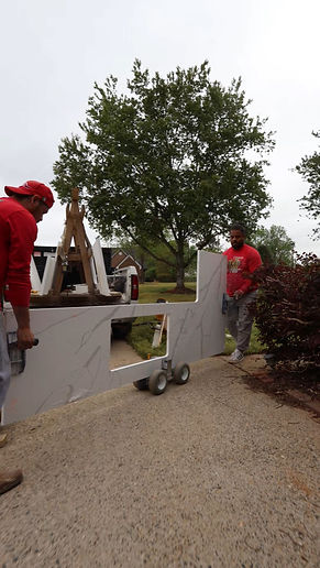 kitchen countertops installers move the pieces into the kitchen in a cart