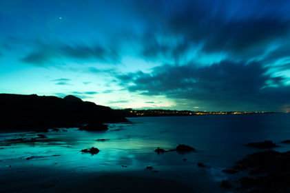 A long exposure photograph from a beach looking towards North Berwick