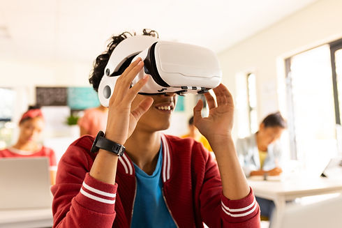 In high school, teenage boy using VR headset in classroom, exploring virtual reality. Tech