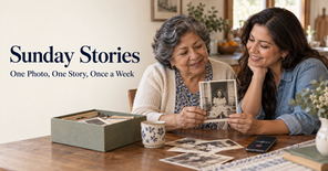 A Hispanic mother and daughter looking at an old photo. Mom is telling the story about the photo.