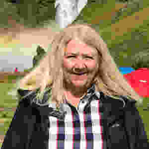 Susan Huff in front of waterfall in Iceland