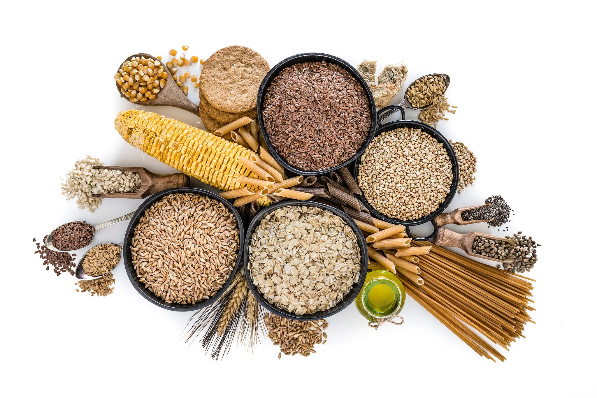 Nuts and grains in bowls on a white background.