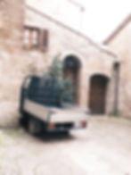 Mini truck parked in stone courtyard