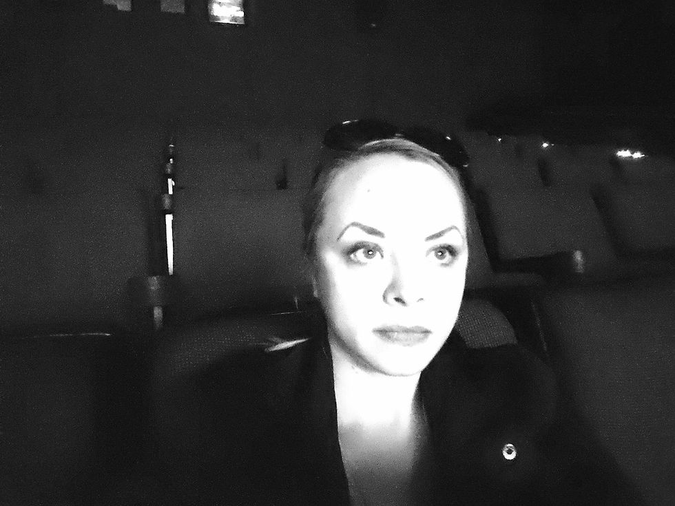Dina in an empty movie theater