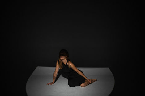 Woman posing in spotlight