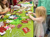 Children making holiday crafts at an event
