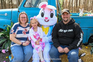 Family with daughter and Easter Bunny in front of a blue truck