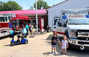 Children at Palmyra fire station event with ambulance & truck